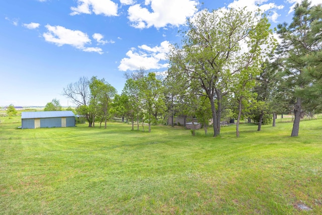 view of yard with an outbuilding and a pole building