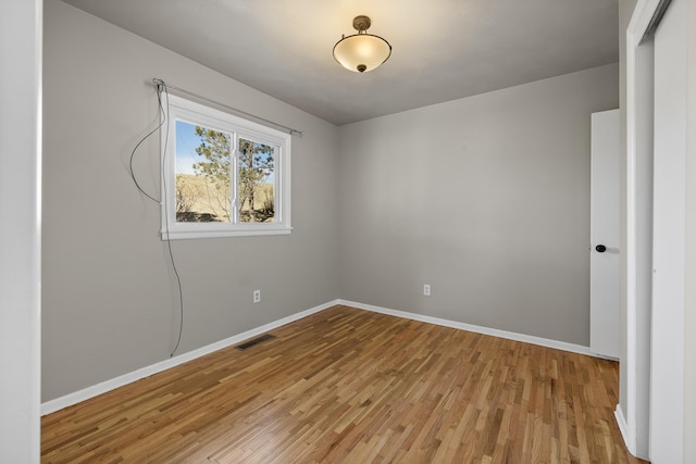 unfurnished bedroom with light wood-style floors, visible vents, and baseboards