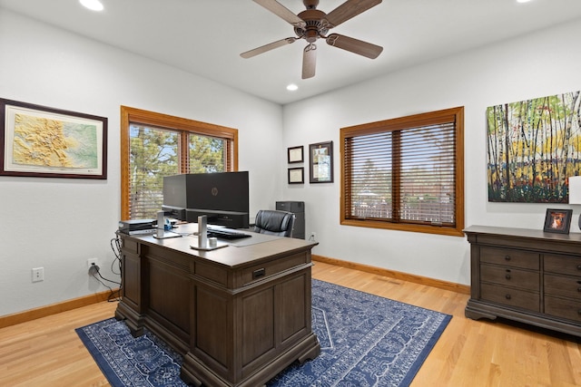 office area with a ceiling fan, recessed lighting, light wood-style flooring, and baseboards