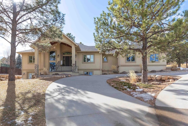 view of front facade featuring concrete driveway and stucco siding