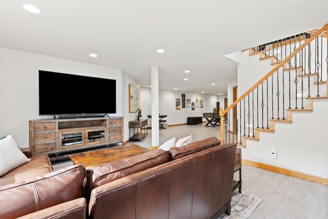 living room featuring stairs, baseboards, and recessed lighting