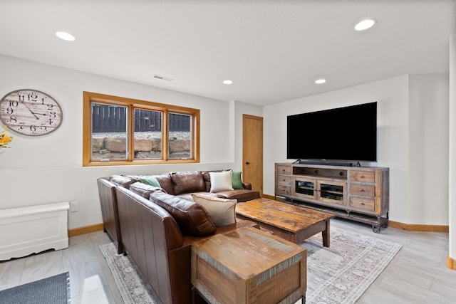 living area with recessed lighting, visible vents, and baseboards