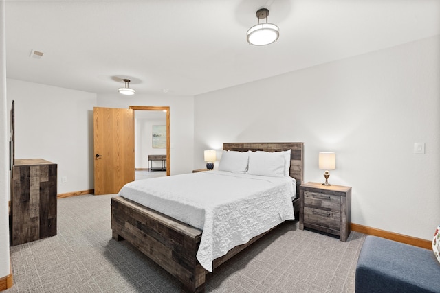 bedroom with light carpet and baseboards