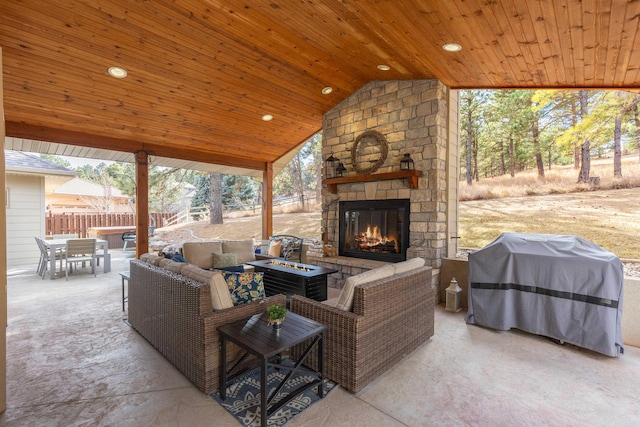 view of patio with outdoor dining space, area for grilling, and an outdoor living space with a fireplace