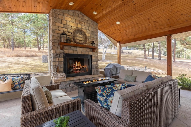 view of patio / terrace with area for grilling and an outdoor living space with a fireplace