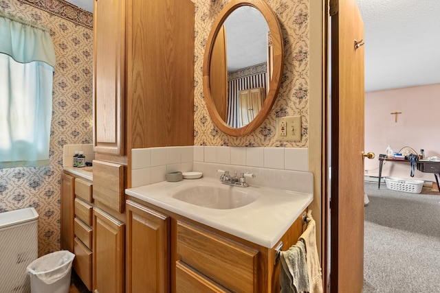 bathroom featuring wallpapered walls and vanity