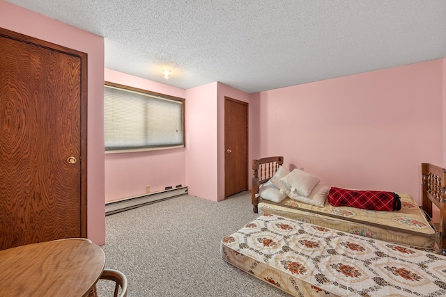 carpeted bedroom featuring a baseboard radiator and a textured ceiling