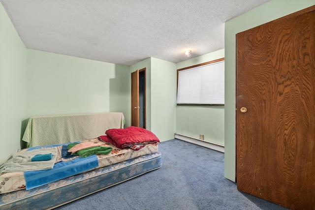 bedroom featuring a baseboard radiator, carpet flooring, and a textured ceiling