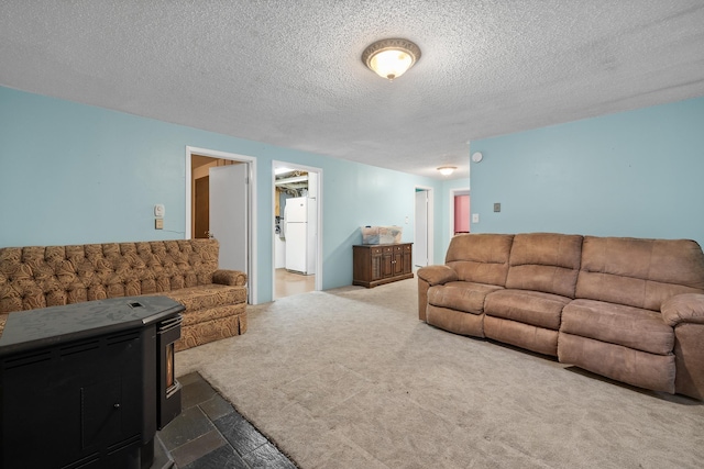 living area featuring a textured ceiling and carpet