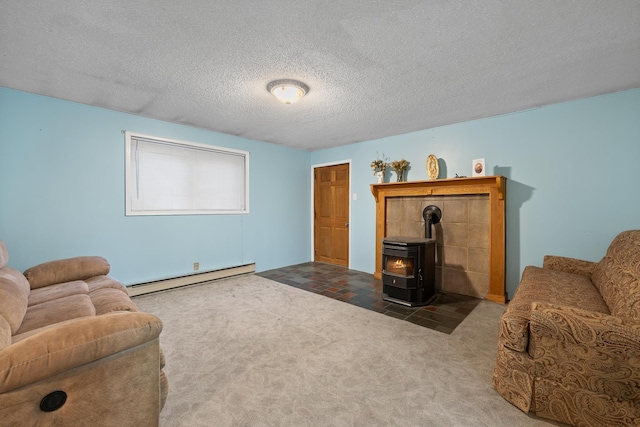 living area with a baseboard radiator, a wood stove, a textured ceiling, and carpet