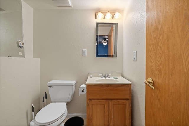 bathroom featuring toilet and vanity