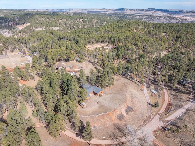 aerial view featuring a mountain view and a view of trees