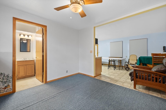 sitting room with light carpet, ceiling fan, light tile patterned floors, and baseboards