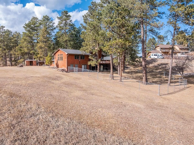 view of yard with an outbuilding and fence