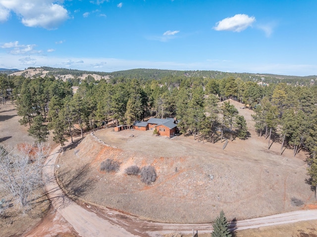 birds eye view of property with a wooded view