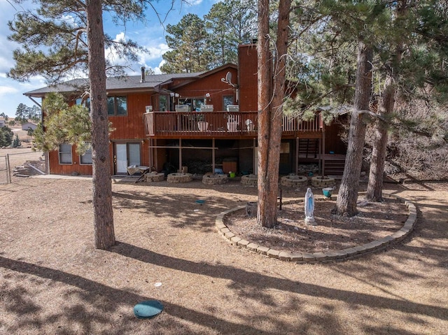 back of property featuring stairs and a wooden deck