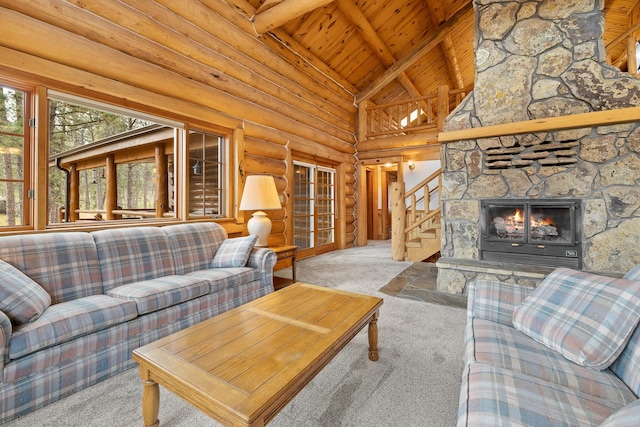 carpeted living room with wooden ceiling, a fireplace, stairway, log walls, and beamed ceiling