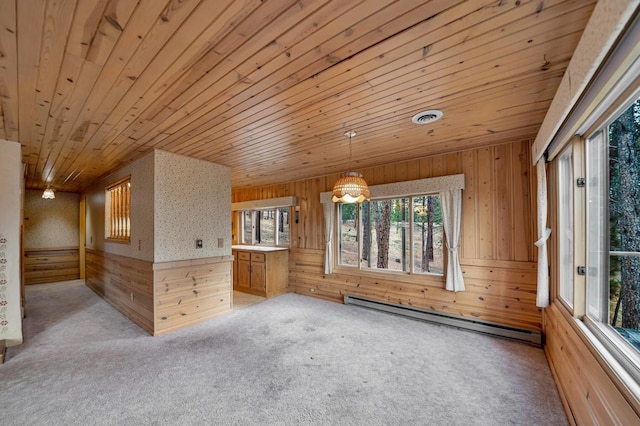 bonus room featuring wood ceiling, visible vents, wood walls, a baseboard heating unit, and carpet flooring