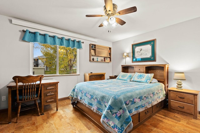 bedroom with ceiling fan, wood finished floors, and baseboards