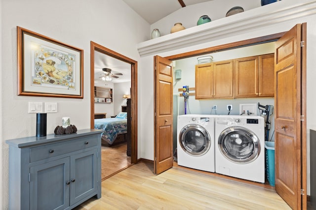 laundry area featuring a ceiling fan, cabinet space, washer and clothes dryer, and light wood finished floors