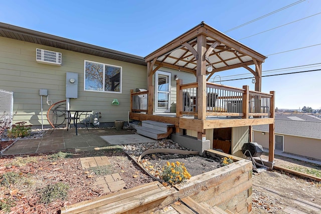 rear view of house featuring a deck and a patio area