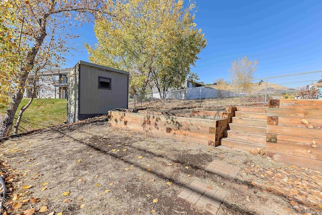 view of yard with a storage shed, an outdoor structure, and fence