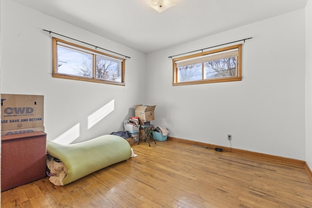 sitting room featuring wood-type flooring and baseboards