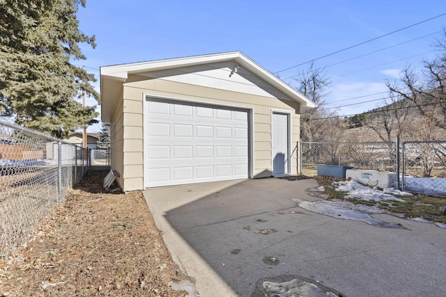 detached garage with driveway and fence