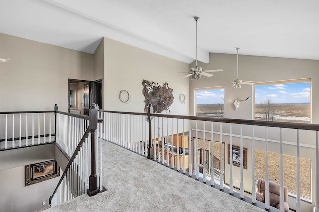 corridor featuring vaulted ceiling with beams, carpet flooring, and an upstairs landing