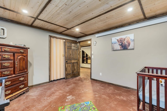 bedroom featuring wooden ceiling, baseboards, and concrete flooring