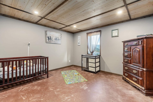 bedroom with concrete flooring, wooden ceiling, and baseboards