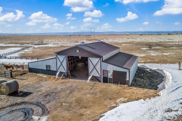 view of outbuilding featuring an outbuilding, an exterior structure, and a rural view