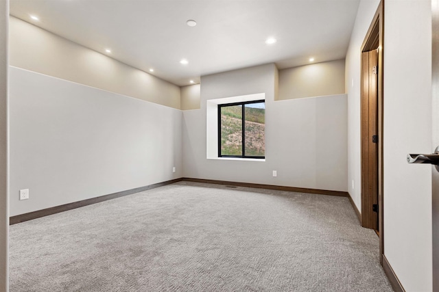 empty room with recessed lighting, carpet, and baseboards