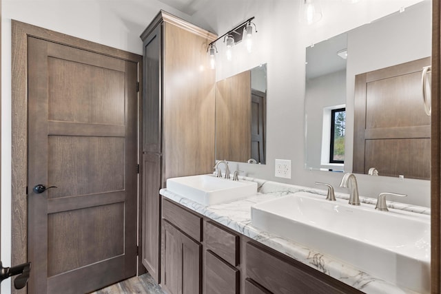 bathroom featuring double vanity and a sink