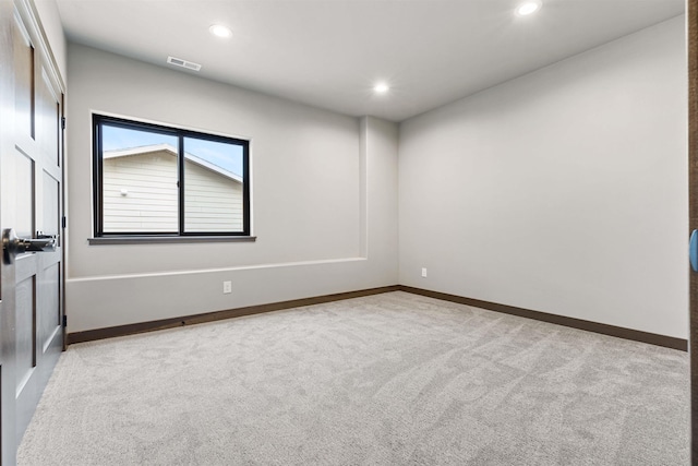 carpeted empty room featuring visible vents, baseboards, and recessed lighting