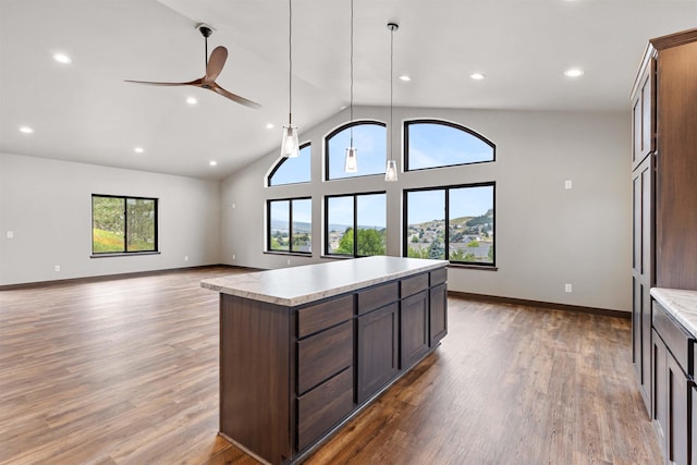 kitchen with light countertops, a kitchen island, and wood finished floors