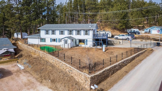 view of front of house featuring fence