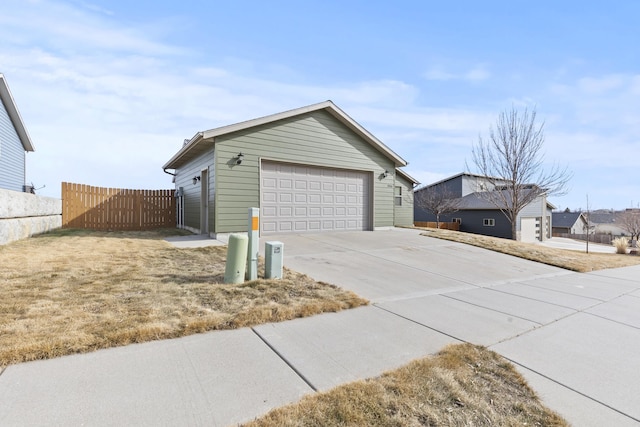 view of home's exterior featuring a garage, fence, and an outdoor structure