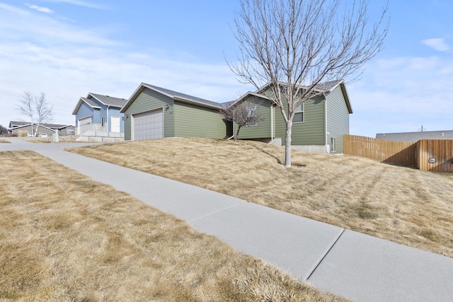 view of front of home with driveway and fence