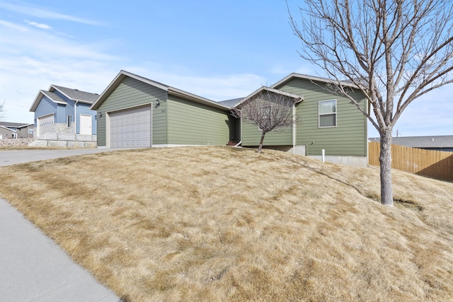 3316 Other, Rapid City, SD 57701 - view of side of home with a garage, concrete driveway, and fence