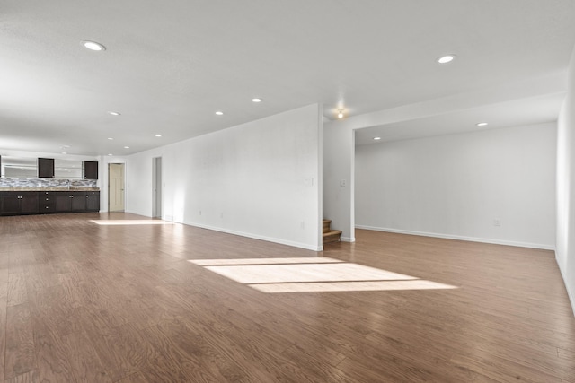 3316 Other, Rapid City, SD 57701 - unfurnished living room with baseboards, stairway, wood finished floors, and recessed lighting