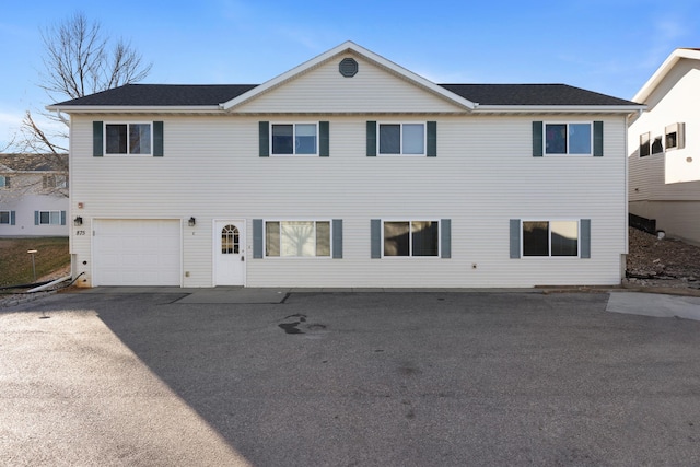 view of front of property featuring a garage and aphalt driveway