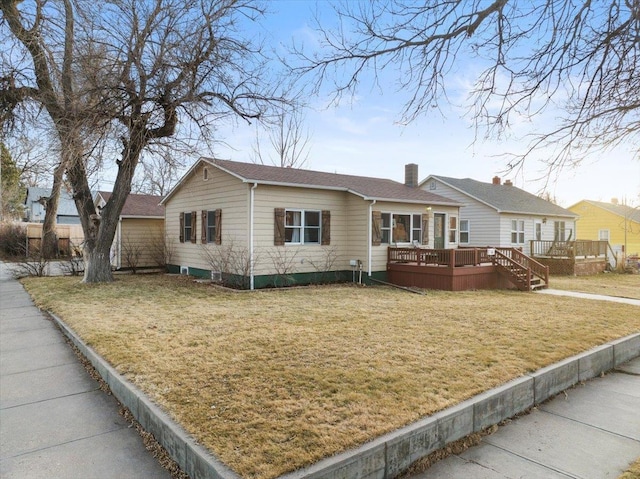 single story home with a wooden deck, a chimney, and a front yard