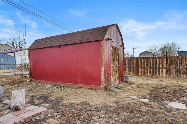 view of shed featuring fence