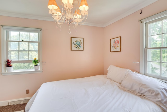 bedroom featuring an inviting chandelier, visible vents, and crown molding