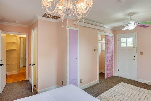 carpeted bedroom featuring ornamental molding, visible vents, and baseboards