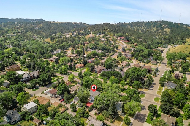 drone / aerial view featuring a forest view and a residential view