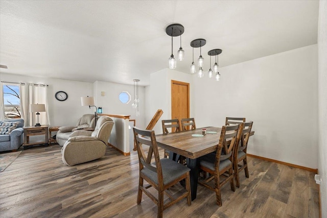 dining room with wood finished floors and baseboards