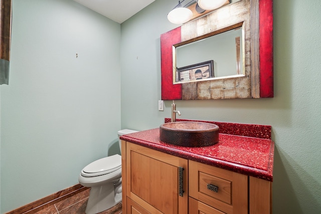 half bath featuring toilet and vanity