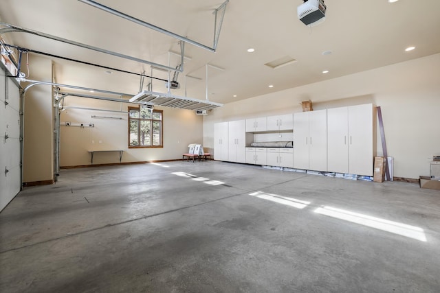 garage featuring recessed lighting, baseboards, and a garage door opener